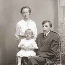 A mother and father posing together as parents.
