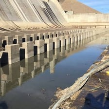 A dam spanning and blocking the flow of a river