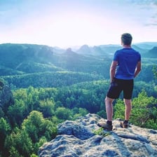 A person looking toward a distant landscape.