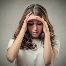 A person appearing remorseful and thoughtful