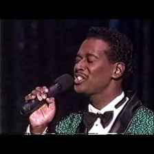 Singer Luther Vandross performing on stage.