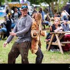 A couple dancing while a musician performs.
