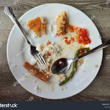 A small morsel of leftover food on a plate.
