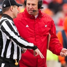 A referee signaling during a sporting event.