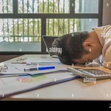 A person placing documents down on a desk.