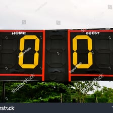 A sports scoreboard displaying a score of zero