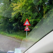 A car traveling past a roadside scene