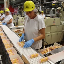 Workers operating machinery in a factory.