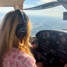 A pilot flying a small airplane alone.