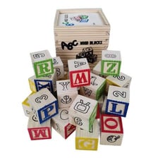 A toddler learning letters with colorful alphabet blocks.