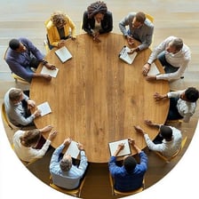 People secretly planning together around a table