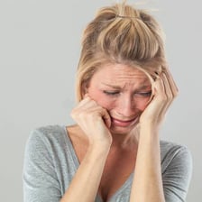 A person displaying an expression of sorrow or regret.