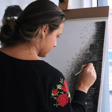 Students working on paintings in an introductory studio art class.