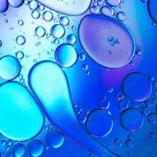A close-up view of oil forming a shiny layer on a surface.
