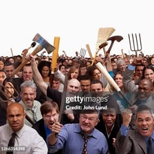 A noisy protest crowd in an uproar