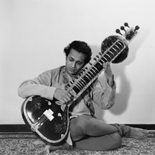 Ravi Shankar performing on a sitar.