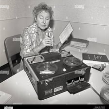 A person using a tape recorder to record audio