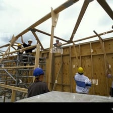 Construction workers putting up the frame of a building