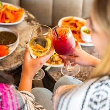 A bar with drinks prepared during happy hour
