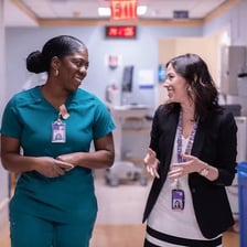 Registered nurses attending to patients in a hospital ward