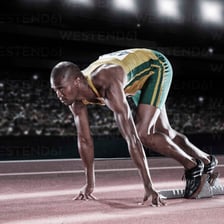 Runner preparing at a starting line.