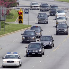 A line of vehicles traveling as a presidential motorcade