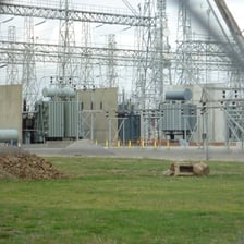 An electrical utility substation with power lines and transformers.