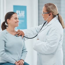 A physician examining a patient in a clinical setting