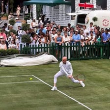 A tennis player serving on a tennis court