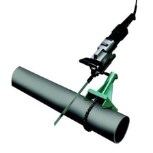 A hand-held hacksaw cutting through a metal pipe