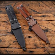 A dagger partly enclosed in a leather sheath.