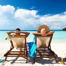 A holidaymaker relaxing beside a beach during a break.