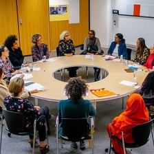 People gathered around a table for a meeting.