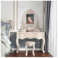 A dressing-table vanity with a mirror and decorative accessories