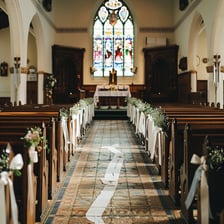 A clear passage running between rows of seats in a church