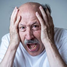 A person showing a frightened, nervous expression.