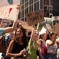 People taking part in a public demonstration with protest placards
