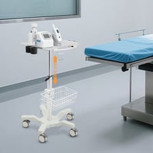 An orderly moving a medical cart through a hospital corridor.