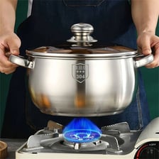 A large cooking pot containing stew on a kitchen stove