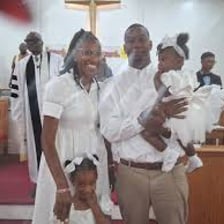 A christening ceremony taking place in a church.