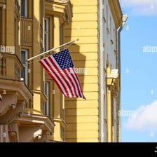 A diplomatic embassy building displaying a national flag