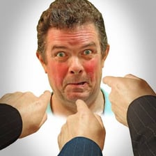 A person with a visibly embarrassed, reddened face.