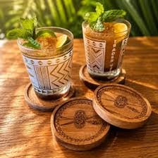 A drinking glass standing on a coaster