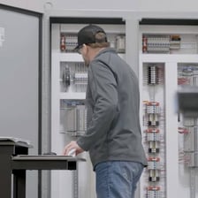 A person running machinery from a control panel.