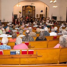 A congregation attending religious services in a church