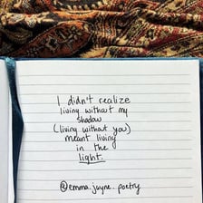 Handwritten lines of poetry in a notebook
