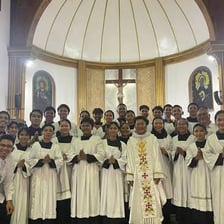 A vicar conducting a service in a church.