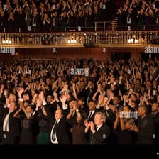 An audience applauding in praise.
