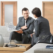 A sales representative showing a product to a customer.