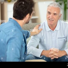 One person reassuring another with a supportive gesture.